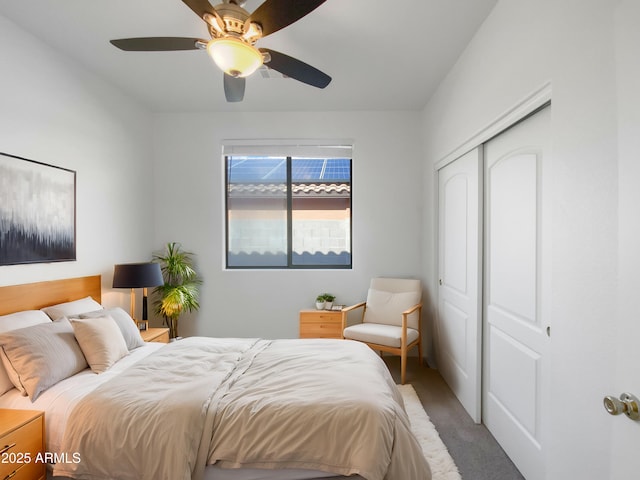 carpeted bedroom featuring a closet and ceiling fan