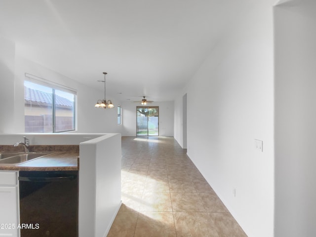 interior space featuring light tile patterned floors, a notable chandelier, and a sink