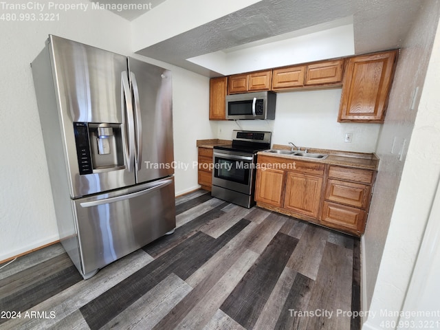 kitchen with sink, dark wood-type flooring, and appliances with stainless steel finishes