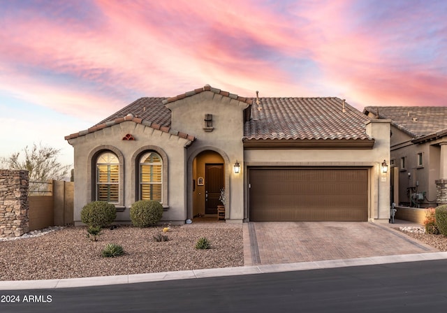 mediterranean / spanish home featuring a garage