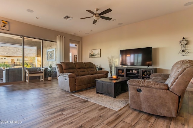 living room with ceiling fan and light hardwood / wood-style floors