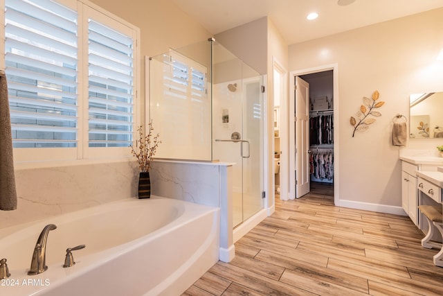 bathroom featuring shower with separate bathtub and vanity