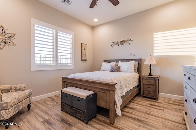 bedroom with ceiling fan and light hardwood / wood-style floors