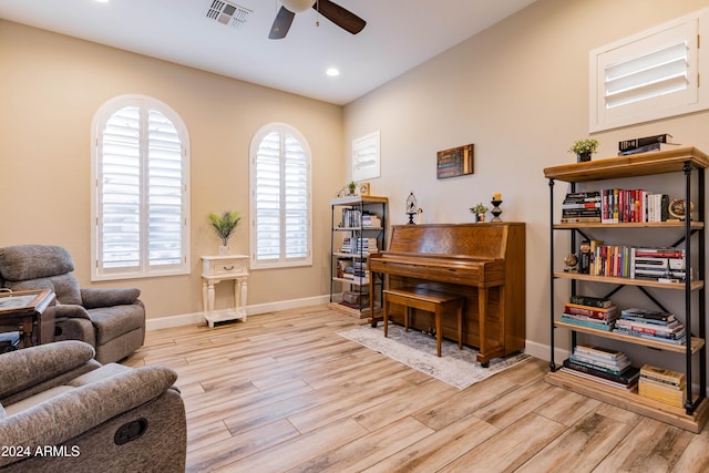 living area featuring ceiling fan and light hardwood / wood-style flooring