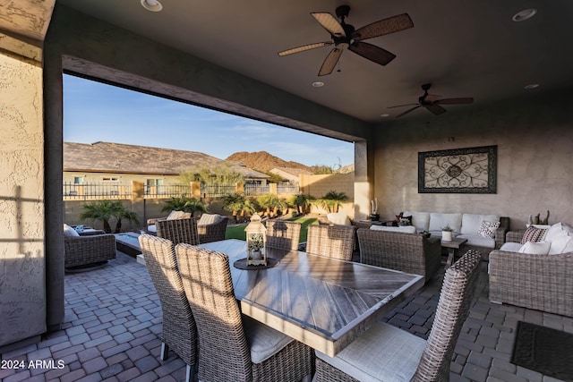 view of patio with a mountain view, ceiling fan, and an outdoor living space