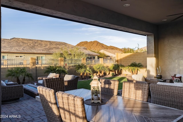 view of patio / terrace featuring a mountain view, an outdoor hangout area, and ceiling fan