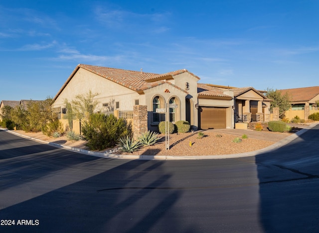 mediterranean / spanish-style house featuring a garage