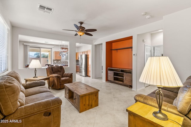 tiled living room with ceiling fan