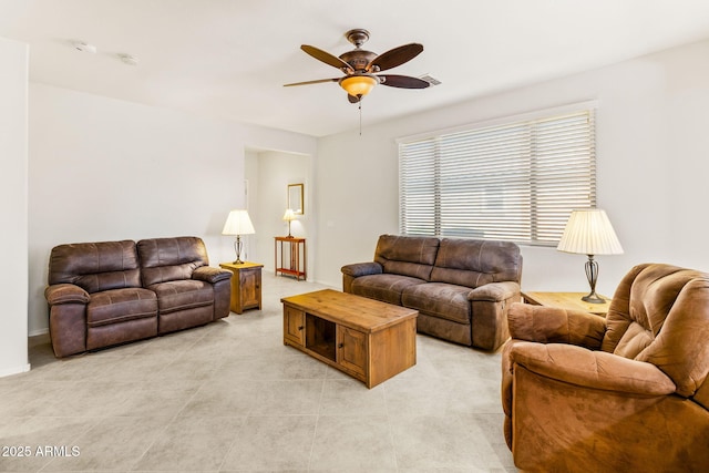 tiled living room with ceiling fan