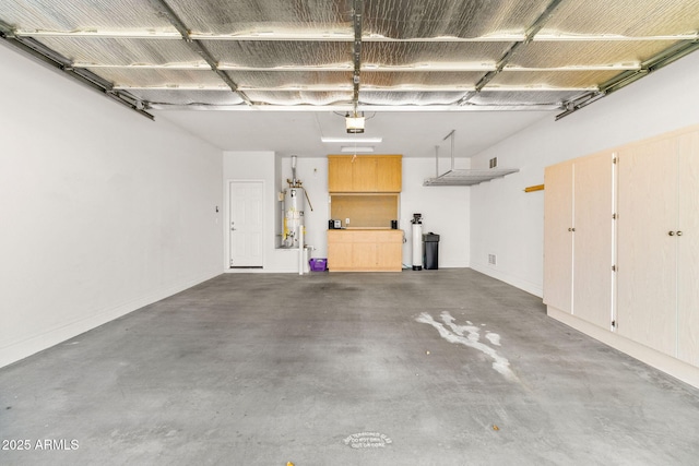 garage with water heater and a garage door opener