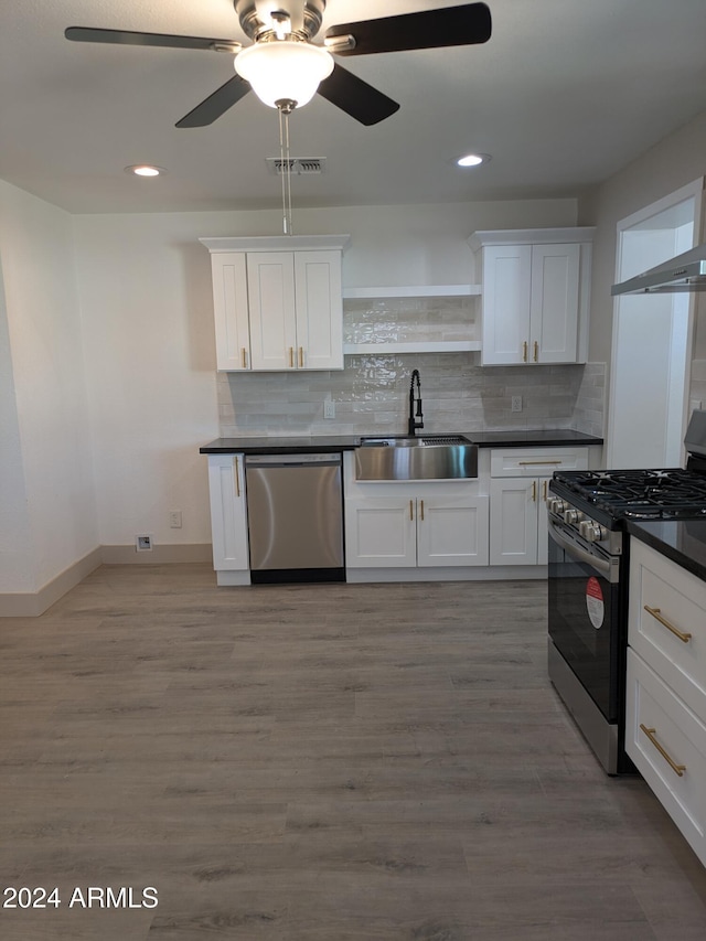 kitchen featuring white cabinets, sink, hardwood / wood-style flooring, and stainless steel appliances