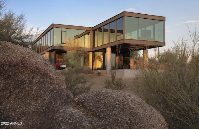 back of house featuring a sunroom