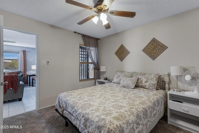 bedroom with a textured ceiling, carpet floors, and a ceiling fan