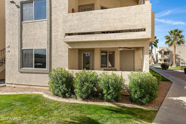 exterior space featuring a balcony and stucco siding