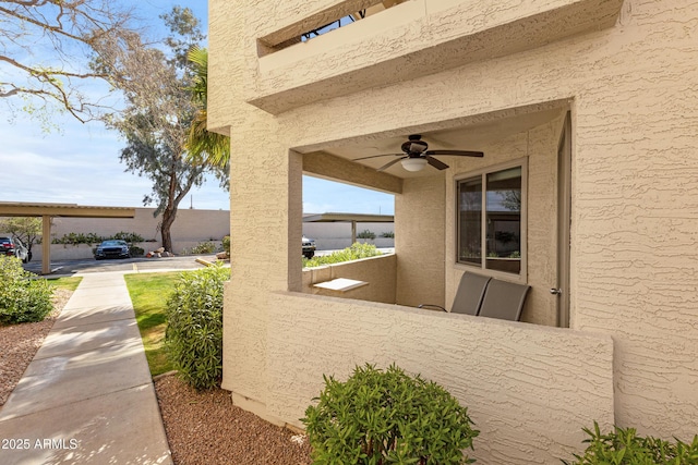 view of property exterior with ceiling fan and stucco siding