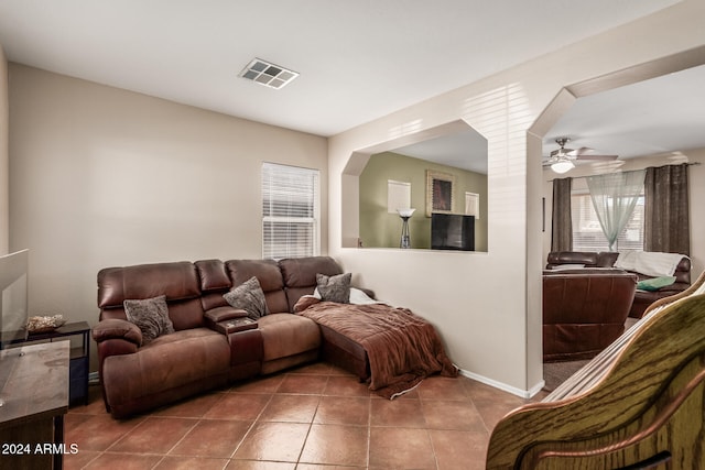 living room with tile patterned flooring and ceiling fan