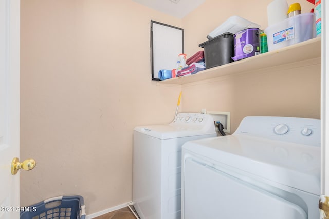 laundry room with washer and dryer and tile patterned floors