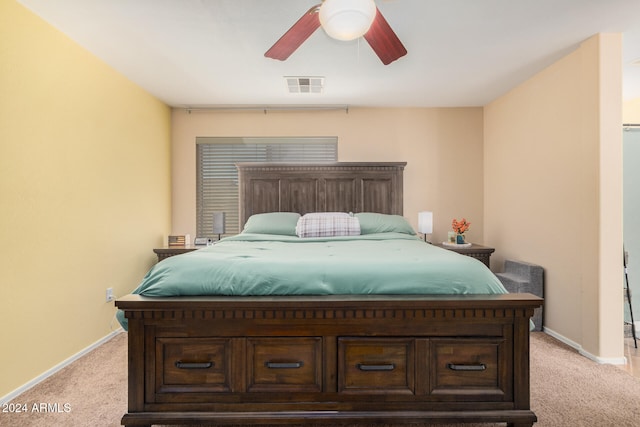 bedroom featuring ceiling fan and light carpet