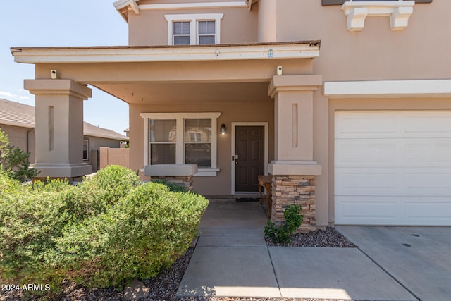 doorway to property with a garage