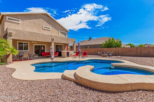 view of swimming pool with an in ground hot tub, exterior kitchen, and a patio