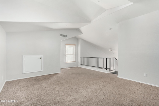 additional living space with lofted ceiling, carpet flooring, visible vents, and baseboards