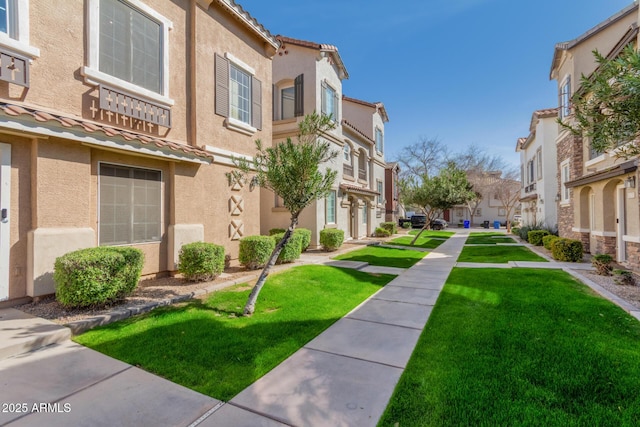 view of community featuring a residential view and a yard