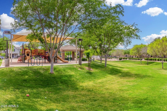 surrounding community featuring playground community and a lawn