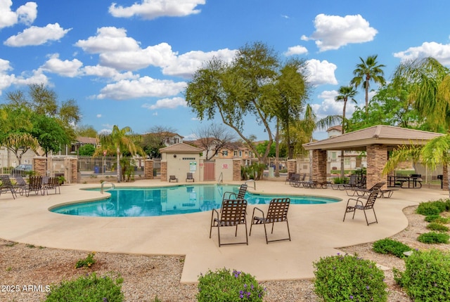 community pool featuring a patio area and fence