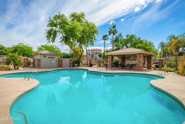 pool with fence, a gazebo, and a patio