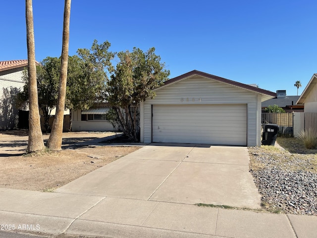 8114 E Jackrabbit Rd, Scottsdale, AZ 85250 - view of front of home featuring driveway and an attached garage