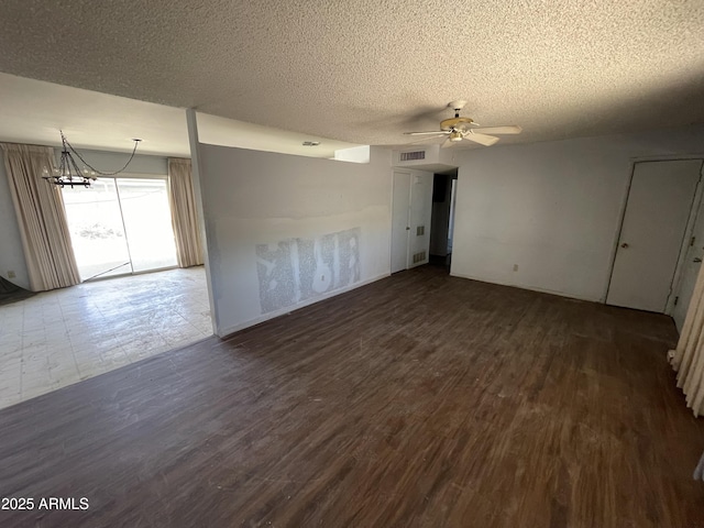 8114 E Jackrabbit Rd, Scottsdale, AZ 85250 - spare room with a textured ceiling, a chandelier, wood finished floors, and a ceiling fan