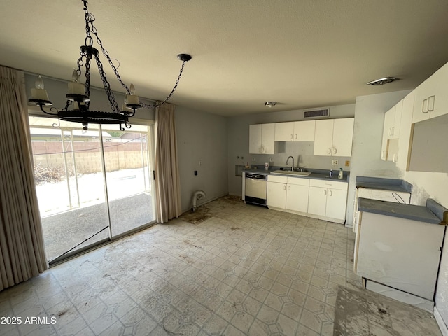 8114 E Jackrabbit Rd, Scottsdale, AZ 85250 - kitchen with dishwasher, dark countertops, white cabinetry, tile patterned floors, and hanging light fixtures