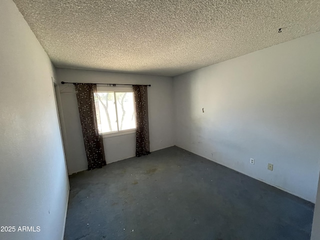 8114 E Jackrabbit Rd, Scottsdale, AZ 85250 - empty room with a textured ceiling and concrete flooring