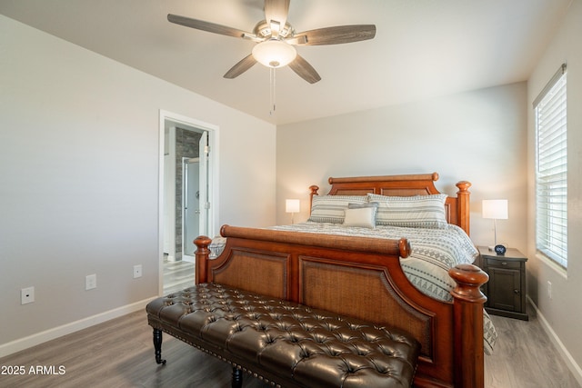 bedroom with baseboards, a ceiling fan, light wood finished floors, and multiple windows