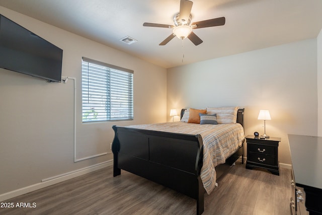 bedroom with visible vents, baseboards, ceiling fan, and wood finished floors