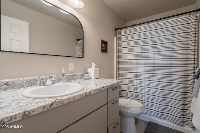 bathroom featuring vanity, toilet, and curtained shower