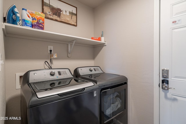 washroom with separate washer and dryer and laundry area
