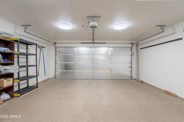 garage with baseboards and a garage door opener