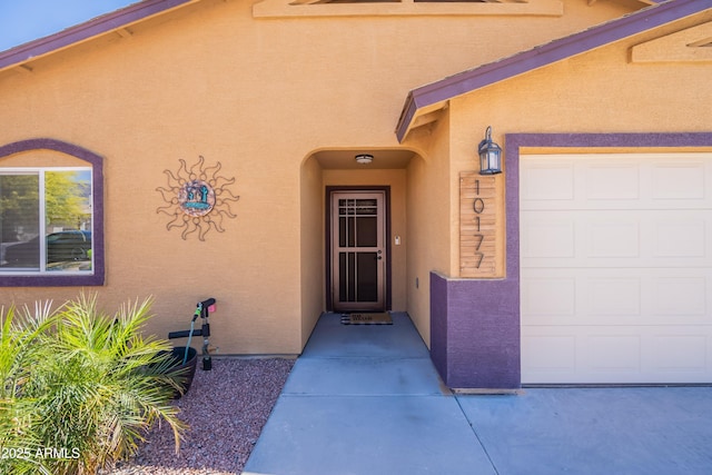 entrance to property featuring stucco siding