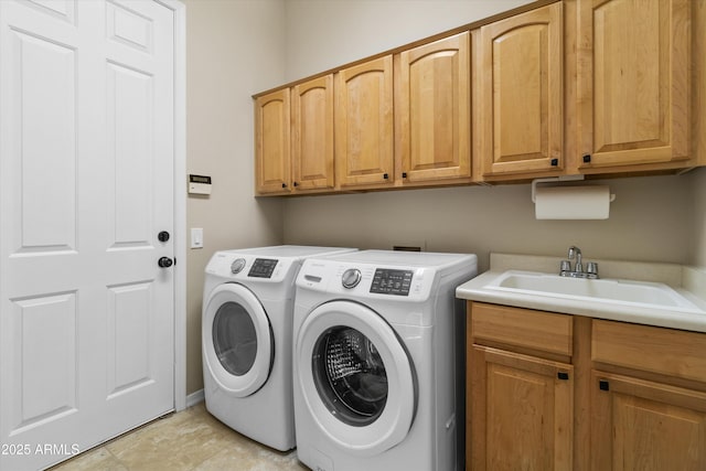 washroom featuring cabinets, independent washer and dryer, sink, and light tile patterned floors