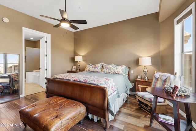 bedroom featuring ensuite bathroom, ceiling fan, and hardwood / wood-style flooring