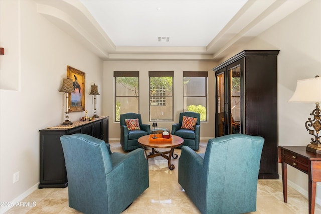 sitting room featuring a raised ceiling