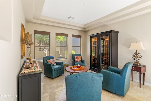 sitting room featuring a raised ceiling