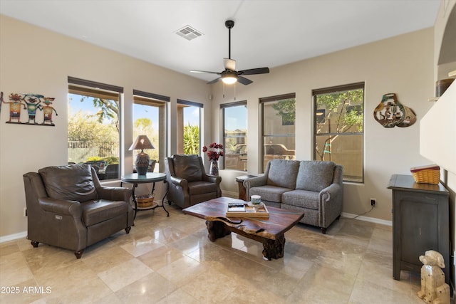 living room with plenty of natural light and ceiling fan