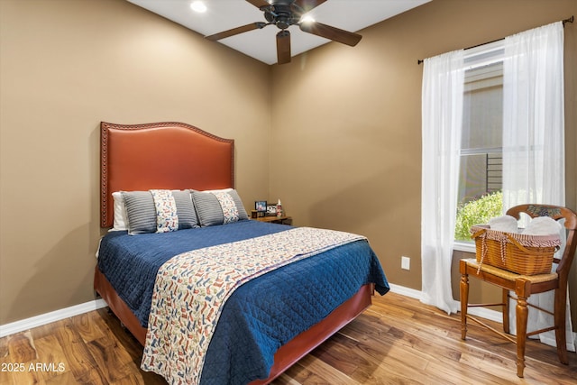 bedroom with hardwood / wood-style flooring and ceiling fan