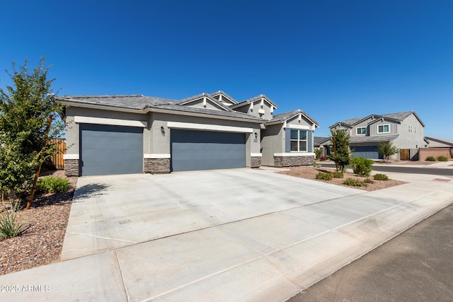 1370 W Siboney St, San Tan Valley, AZ 85143 - view of front of property with concrete driveway, stone siding, stucco siding, and a garage