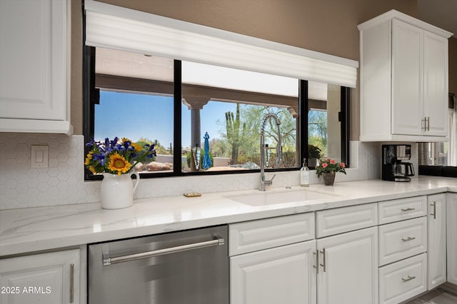 8601 E De La O Rd, Scottsdale, AZ 85255 - kitchen with stainless steel dishwasher, a sink, tasteful backsplash, white cabinetry, and light stone countertops