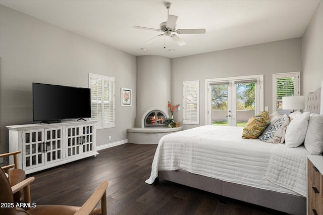 8601 E De La O Rd, Scottsdale, AZ 85255 - bedroom with wood finished floors, baseboards, a ceiling fan, and a fireplace