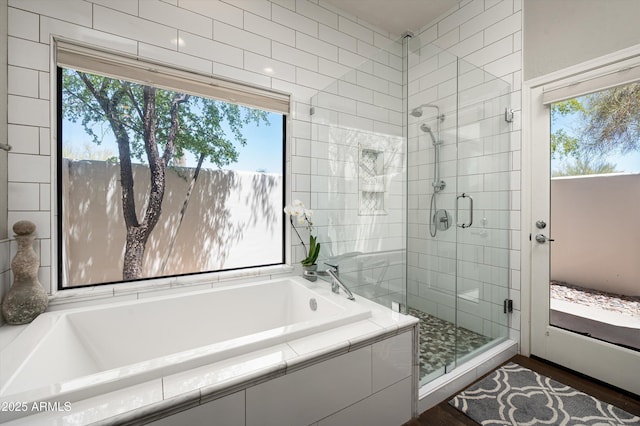 8601 E De La O Rd, Scottsdale, AZ 85255 - bathroom featuring a stall shower, a garden tub, and wood finished floors