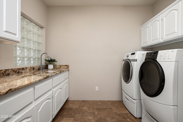 8601 E De La O Rd, Scottsdale, AZ 85255 - laundry room with separate washer and dryer, cabinet space, and dark stone finish floors